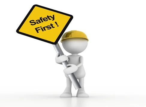 Representative figure holding a reminder sign for safety first.